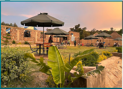 Outdoor seating at Planet Breeze gardens at golden hour