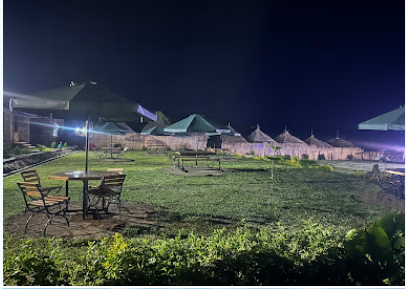 Planet Breeze gardens at night with lit umbrellas and gazebos